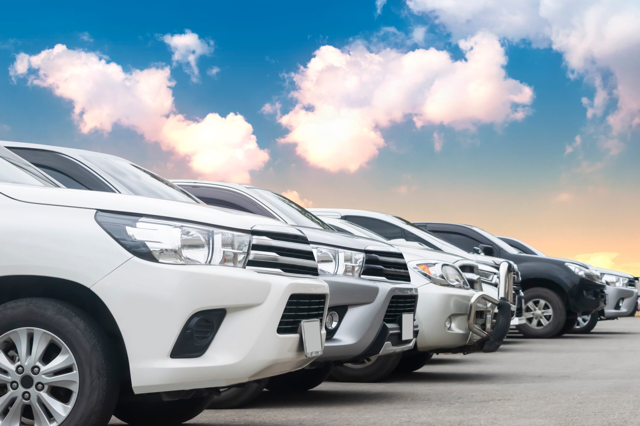 Lined up fleet cars in front of a sunset