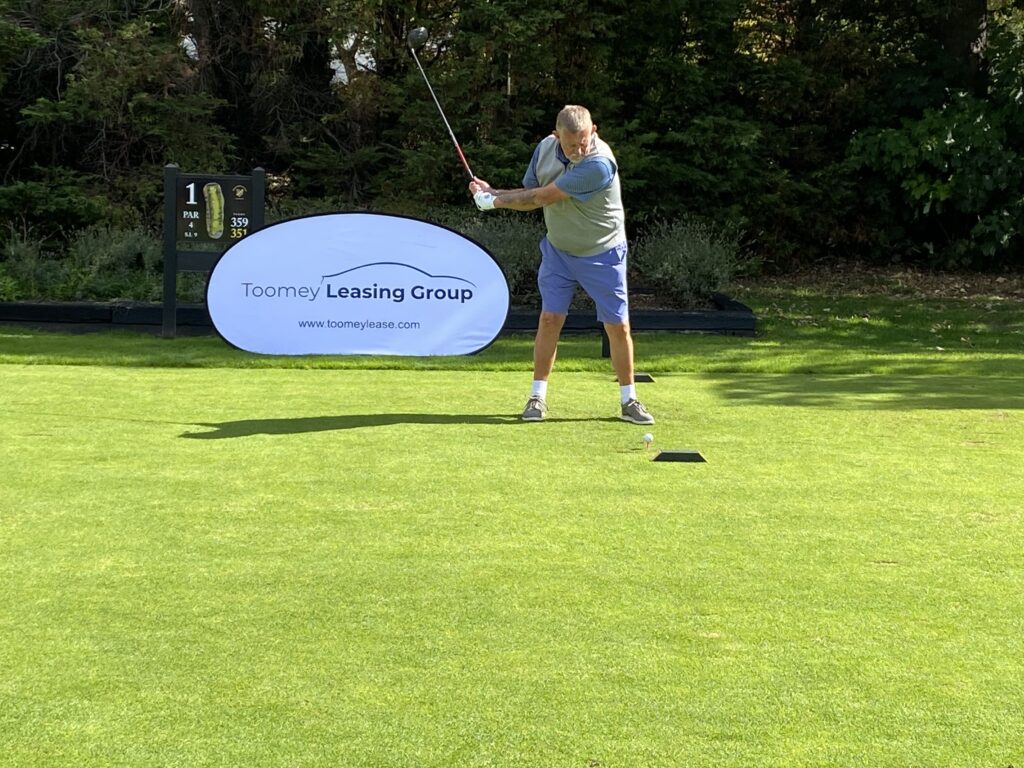 Client teeing up a golf shot
