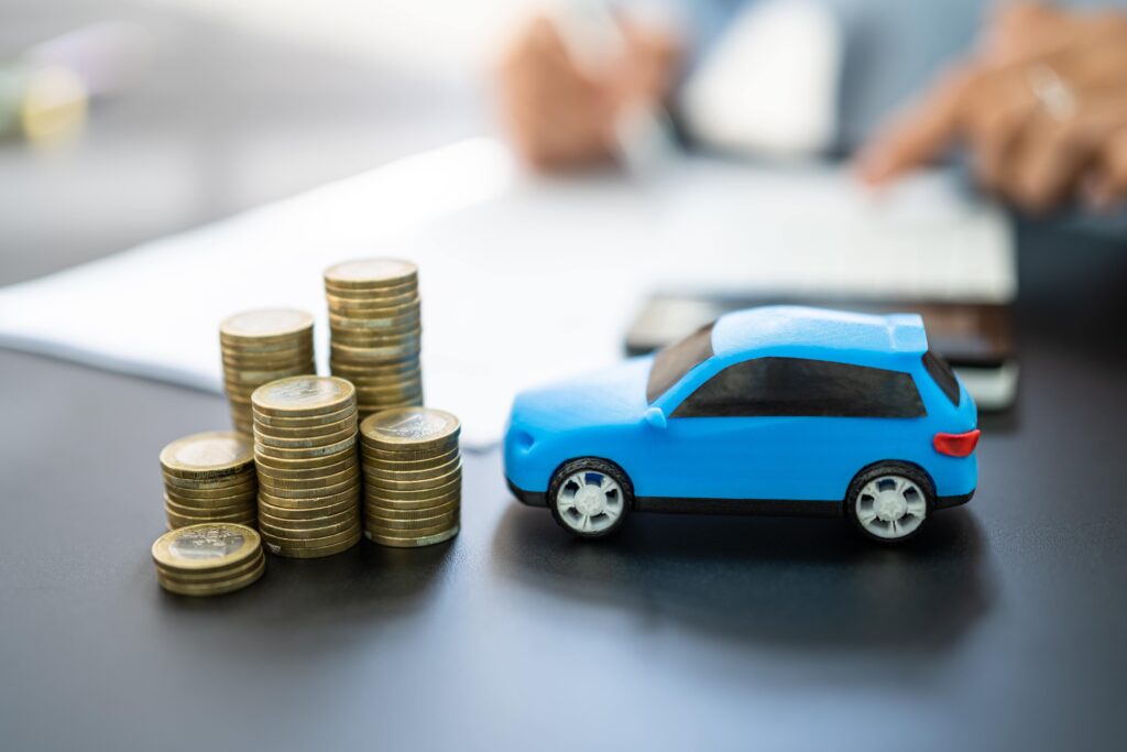 blue toy car next to stack of coins