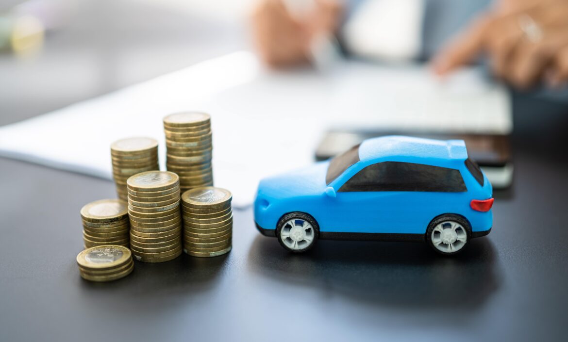 blue toy car next to stack of coins