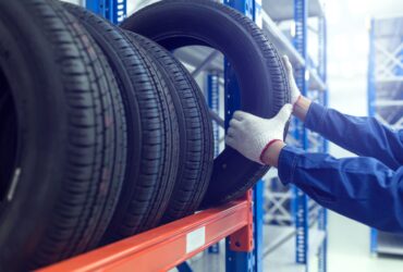 Focused shot of technician selecting tyre from tyre rack