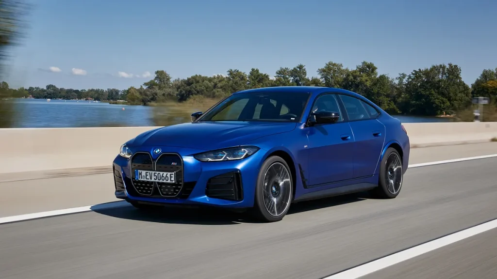 BMW i4 driving on road towards camera