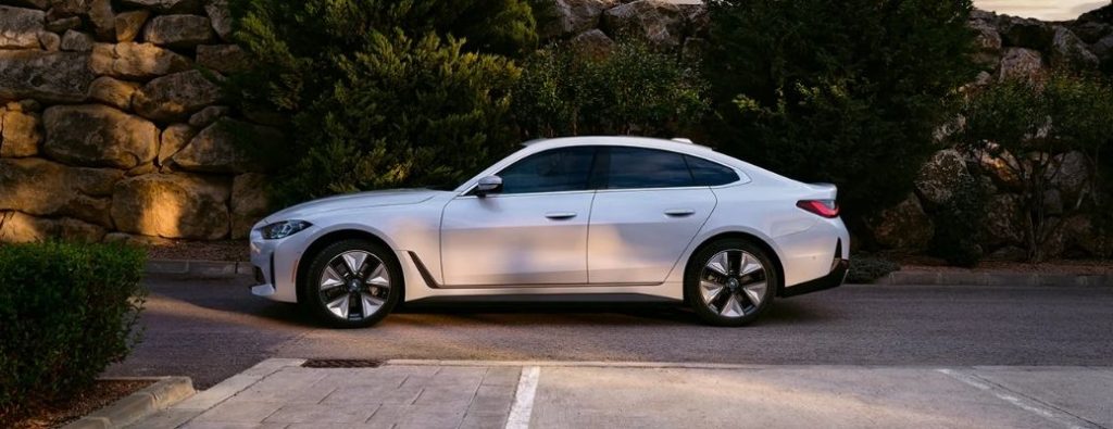 BMW i4 side profile in a suburban area