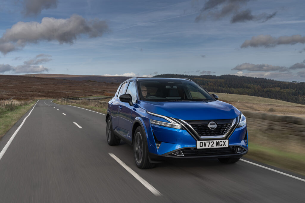 Nissan Qashqai e-POWER driving along a country road, towards the screen.