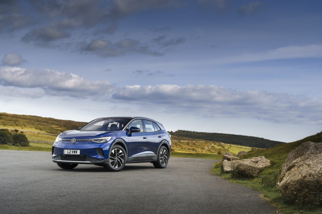 Blue Volkswagen ID in scenic landscape background, Parked and facing the camera.