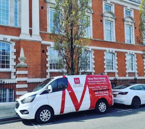 Masterfix branded van parked outside old decorative building