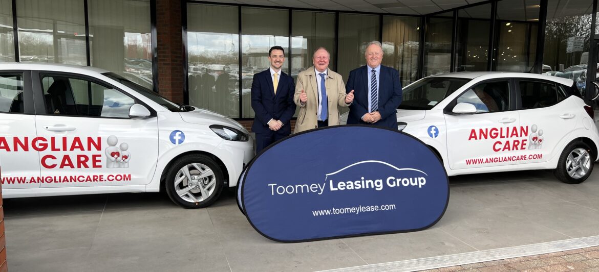 3 Businessmen next to new cars