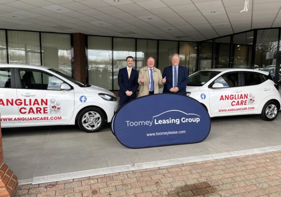 3 Businessmen next to new cars