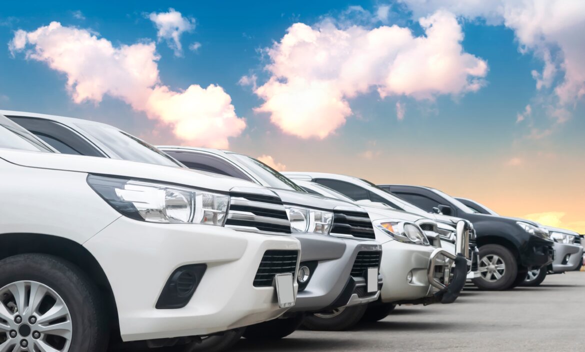 Lined up fleet cars in front of a sunset