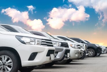 Lined up fleet cars in front of a sunset